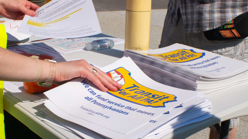 A close-up of someone handing out an advocacy report.